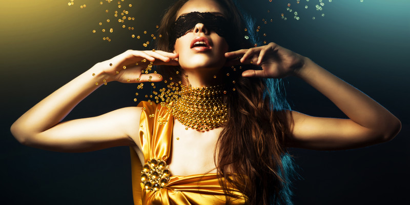 woman in yellow dress and mask with jewelry